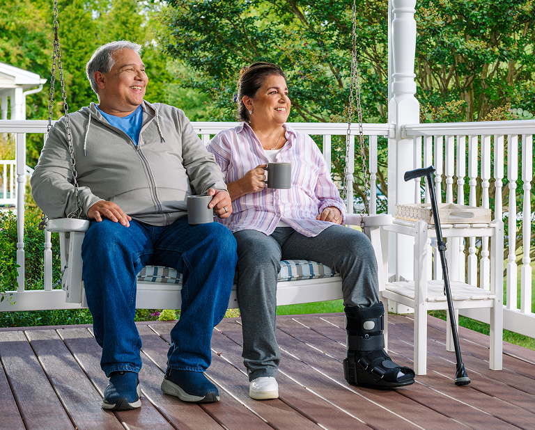 Older couple enjoying coffee on a porch swing