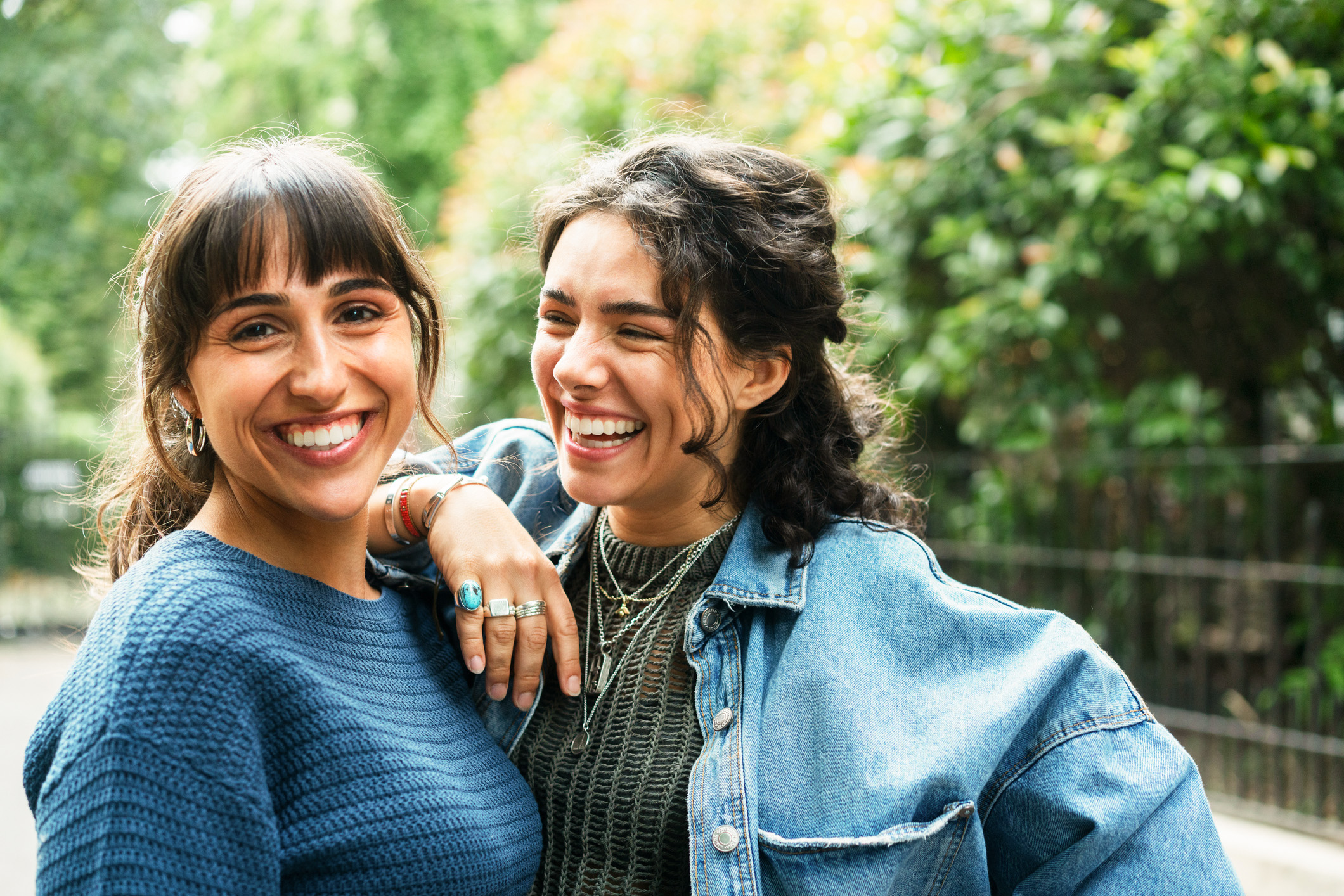 Two members smiling together outdoors