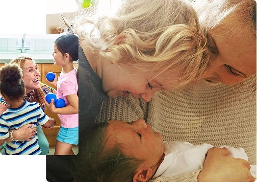 Young child smiles at new born baby in mother's arms