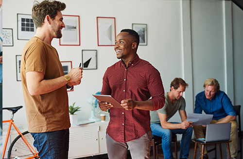 Two teammates have discussion in modern workplace