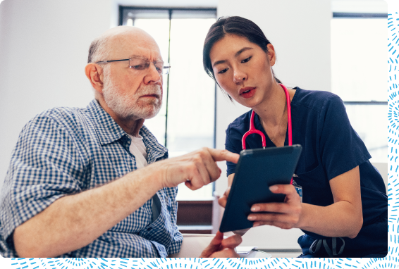 Person looking at tablet with doctor
