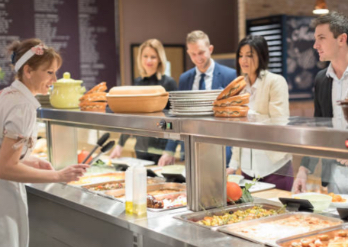 Employees getting food in the cafeteria