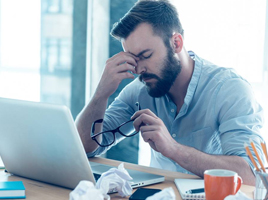 A man feeling stressed at work