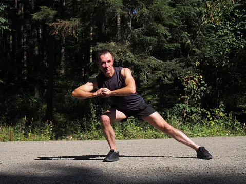 Man stretching inner thigh