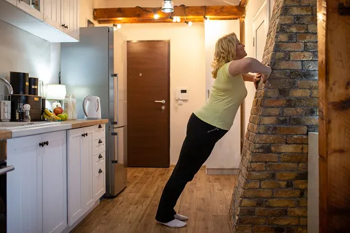 Woman doing wall pushups
