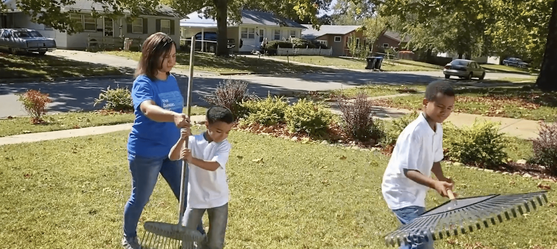 Family raking leaves