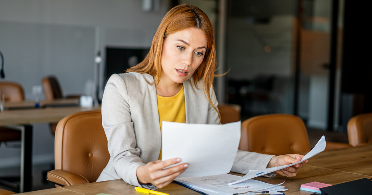 Person reviewing paperwork in an office