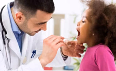 A little girl getting checked by a doctor
