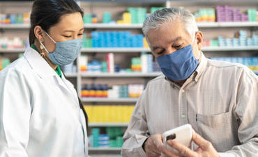 Photo of pharmacist helping a patient with their prescription