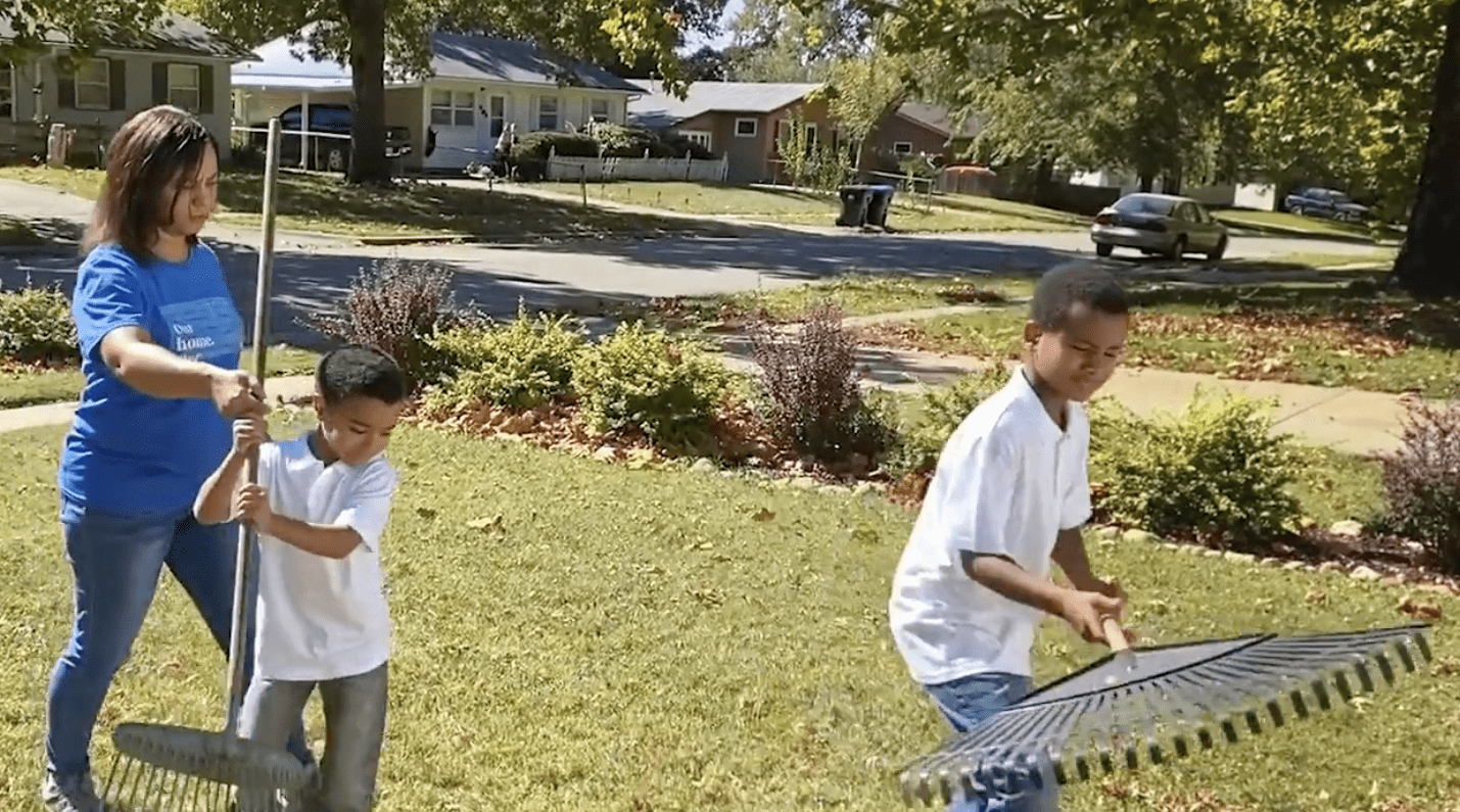 Family raking leaves