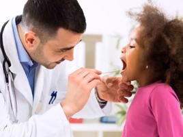 A little girl getting checked by a doctor