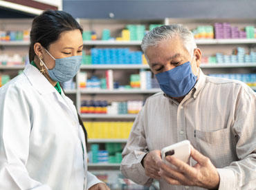 Photo of pharmacist helping a patient with their prescription