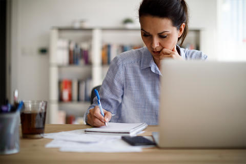 Woman writing down goals