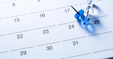 a calendar with thumb tacks