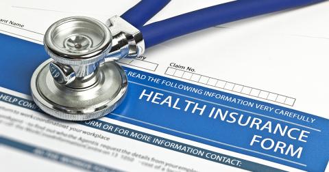 a stethoscope on top of an insurance form