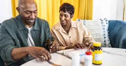 A couple reviews their prescription pills