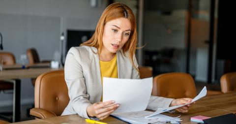 Person reviewing paperwork in an office
